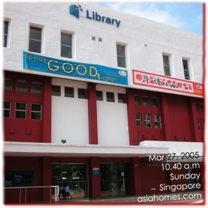 Small boy waiting for the library to open on a Sunday in Singapore